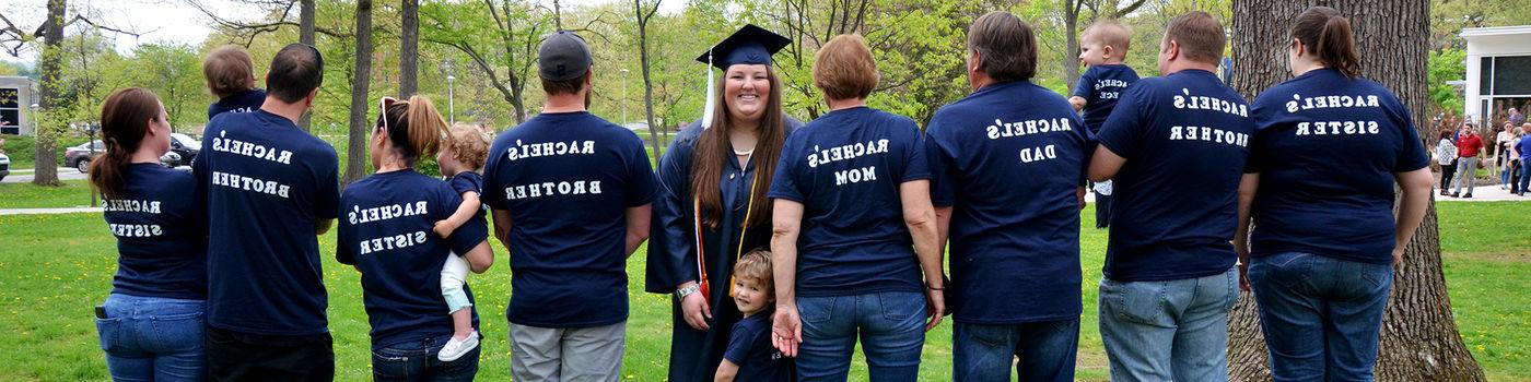 一位名叫瑞秋的应届毕业生与家人合影, 他们都穿着印有她名字的t恤.